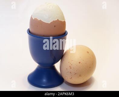 boiled, peeled egg in cup on white background Stock Photo