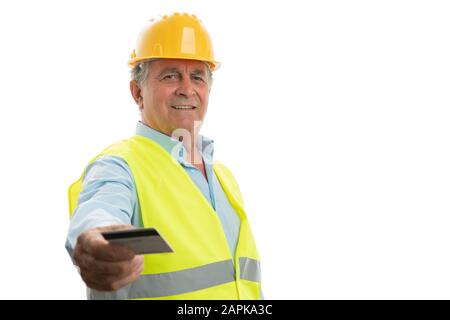 Friendly old male engineer with trustworthy expression presenting credit card as cashless concept isolated on white Stock Photo