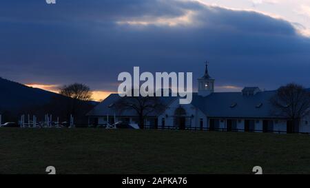 Sun setting behind Chapel Spring barn in the Blue Ridge Mountains. Stock Photo