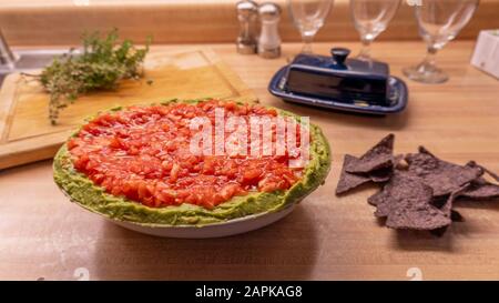 Mexican salsa dip and nacho tortillia chips on a kitchen counter Stock Photo