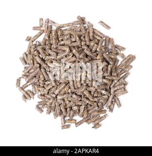 Pile of dry grass pellets for rodents isolated on white background. Food for hamsters, rabbits, chinchillas and other. Stock Photo