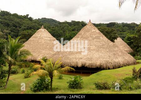 Beautiful Embera village in Panama. This is home for embera people,thatched roof is covered every house. Small village in the middle of the jungles. Stock Photo