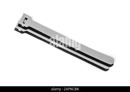 Black and grey Velcro Strips isolated on white background.Devices for storing cables, chargers Gadget tidy Stock Photo