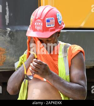 Mount Pleasant, Wisconsin, USA. 19th July, 2019. Work on a construction project continues as temperatures were in the low 90s (F) in the Village of Mount Pleasant near Racine, Wisconsin. Extremely hot weather has started to hit most of the United States, according to meteorologists. Credit: Mark Hertzberg/ZUMA Wire/Alamy Live News Stock Photo