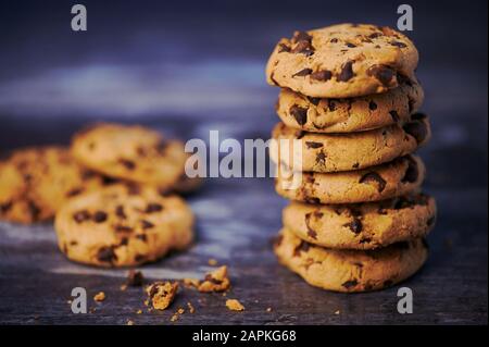 pile of chocolate cookies against wooden background with copy space Stock Photo