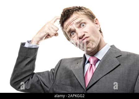 Confused businessman scratching his head looking at the camera with a perplexed expression on white background Stock Photo