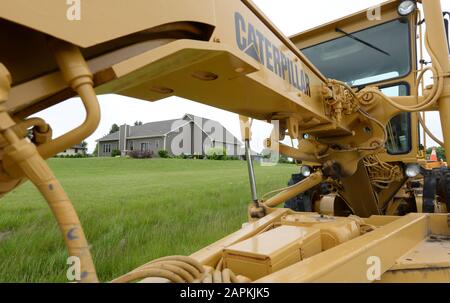 Mount Pleasant, Wisconsin, USA. 11th June, 2018. A house threatened with demolition is framed by construction equipment as work continues on the expansive site for the future Foxconn company facility and Wisconsin Valley Science & Technology Park in the Village of Mount Pleasant, Wisconsin. Credit: Mark Hertzberg/ZUMA Wire/Alamy Live News Stock Photo
