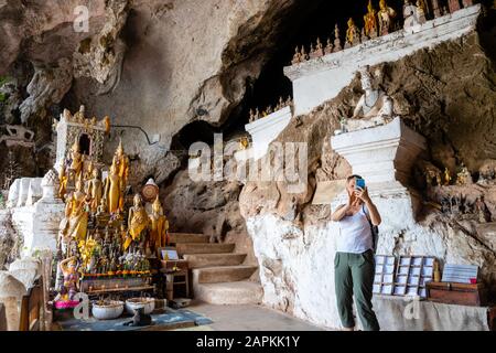 Interior view of the many Buddha statues that are found within the famous Pak Ou Caves, Laos, along the Mekong River. Stock Photo