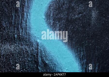 The painted wall is plastered in black. The blue line is in the texture cut. Background. Stock Photo