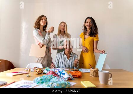 Portrait of confident fashion designers in office Stock Photo
