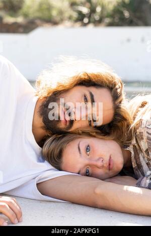 Portrait of young couple head to head outdoors Stock Photo