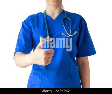 Young female doctor in a blue medical uniform showing a thumbs-up gesture Stock Photo