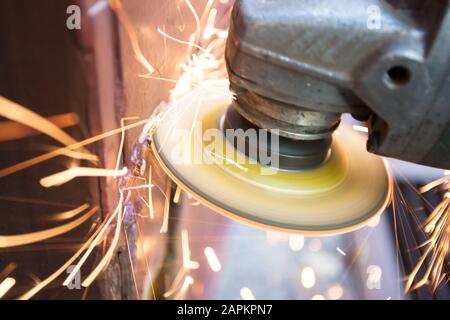 using angle grinder to cut metal Stock Photo