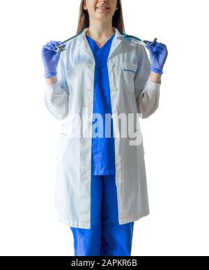 Cheerful young female doctor in a medical uniform wearing sterilized gloves holding a stethoscope Stock Photo