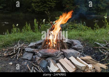 Campfire burning in stone circle Stock Photo