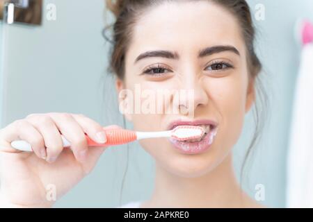 Woman brushing teeth Stock Photo