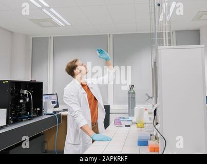 Scientist analyzing a specimen in laboratory Stock Photo