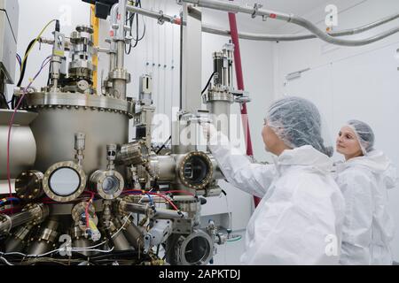 Laboratory technicians working on a device in laboratory of science center Stock Photo