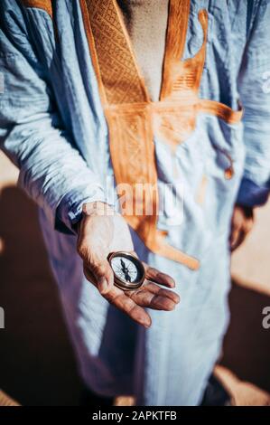 Close-up of senior man holding compass in Smara refugee camp, Tindouf, Algeria Stock Photo