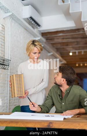 Two architects with architectural model in an office Stock Photo