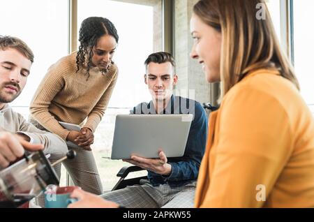 Young business people with laptop having a meeting in office Stock Photo