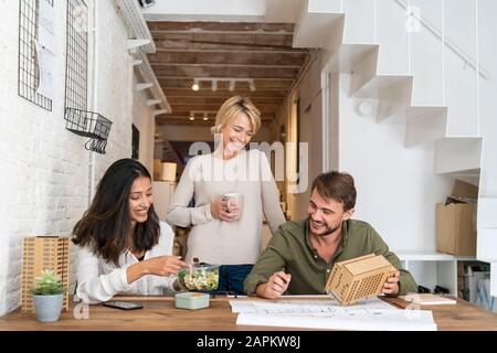 Three colleagues at desk in architect's office Stock Photo