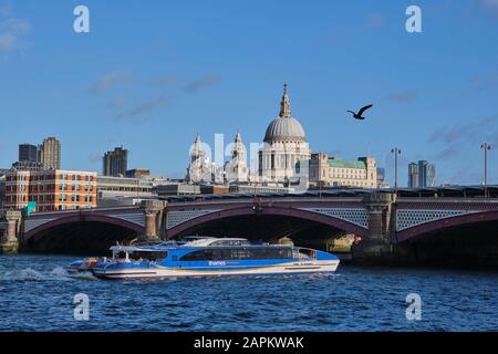 UK, England, London, Tourboat sailing under Blackfriars Bridge with Saint Pauls Cathedral in background Stock Photo
