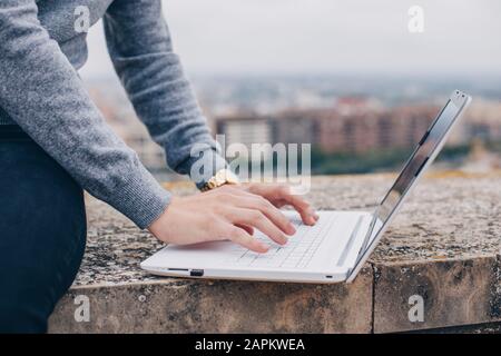 Close-up of a hands of a young man typing on his laptop in Lleida Stock Photo