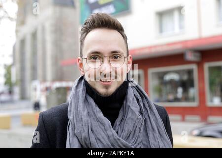 Portrait of smiling young man in the city in winter Stock Photo