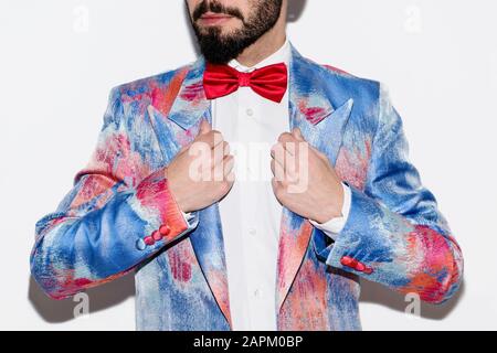 Stylish man wearing a colorful suit and a red bow tie Stock Photo