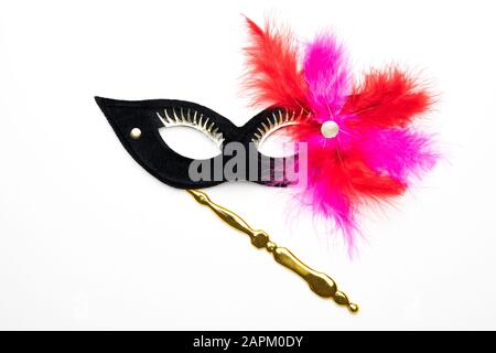 Black festive carnival mask with purple / pink / feathers isolated on a white background Stock Photo