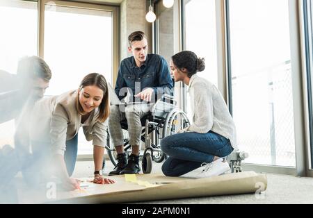 Young business people working together on a project in office Stock Photo