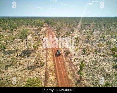 Benin, Aerial view of 4x4 car driving along dirt road in Pendjari National Park Stock Photo