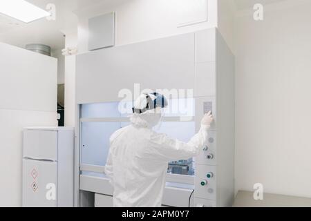 Researcher wearing safety helmet working in laboratory Stock Photo