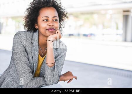 Portrait of smiling young businesswoman outdoors Stock Photo