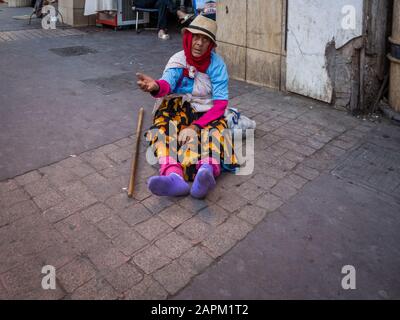 MARRAKECH, MOROCCO - Jun 03, 2018: Anonymous poor beggar in the street of Marrakech, Morocco Stock Photo