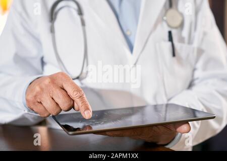 Close-up of doctor using tablet Stock Photo