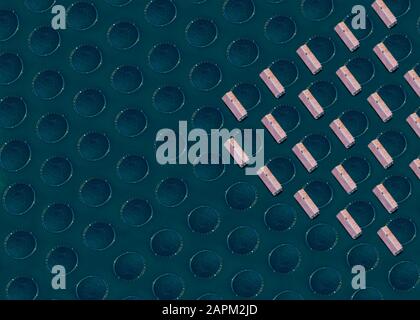 Floting Farm Aerial view of a floating fish farm with wooden structures and net ...