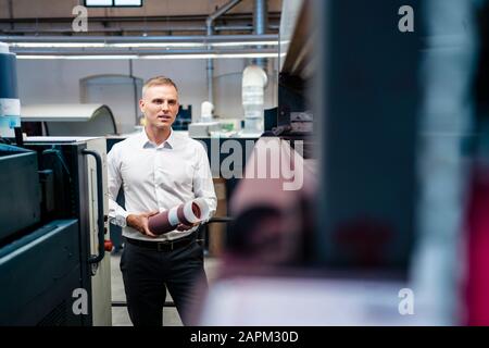 Man in white shirt in a factory Stock Photo
