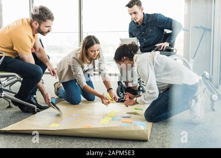 Young business people working together on a project in office Stock Photo