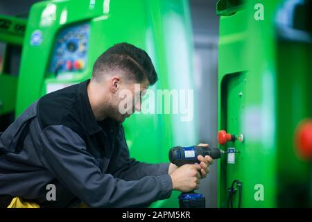 Skilled worker, working in conveyor belt shop Stock Photo