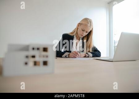 Young businesswoman working at desk in office Stock Photo
