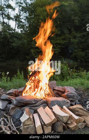 Campfire burning in stone circle Stock Photo