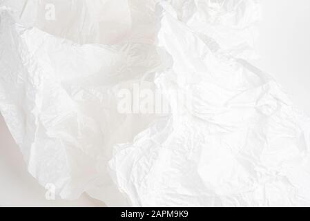 A close-up shot of crumpled delicate white tissue paper set on white background. Stock Photo