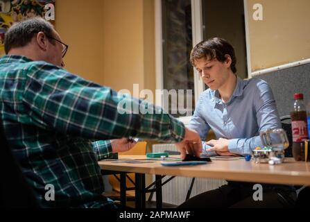 10 January 2020, Hessen, Frankfurt/Main: Cosmo Hahn (18, r) is playing against fellow player Torsten (52, l) in a tournament of the trading card game 'Magic'. Photo: Frank Rumpenhorst/dpa Stock Photo