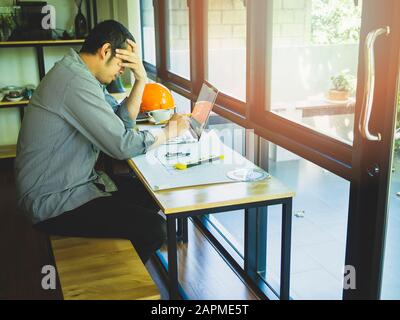 Architect in stress, tired, sad, disappointed with project problem. Stock Photo