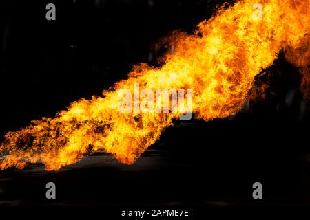 Flames caused by the explosion of the oil isolated on black background. Demonstration of water on oil fire. Stock Photo