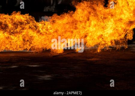 Flames caused by the explosion of the oil isolated on black background. Demonstration of water on oil fire. Stock Photo