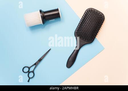Flat lay composition with professional hairdresser tools on pastel color blue and beige background. Tools for hair styling. Brush for brushing hair, c Stock Photo