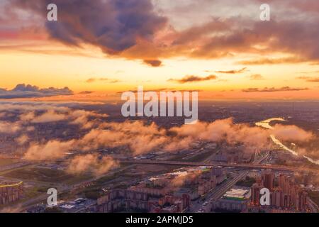 Dramatic sunrise sky with low clouds over the urban panoramic landscape view Stock Photo